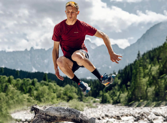 man jumping in true motion running shoes